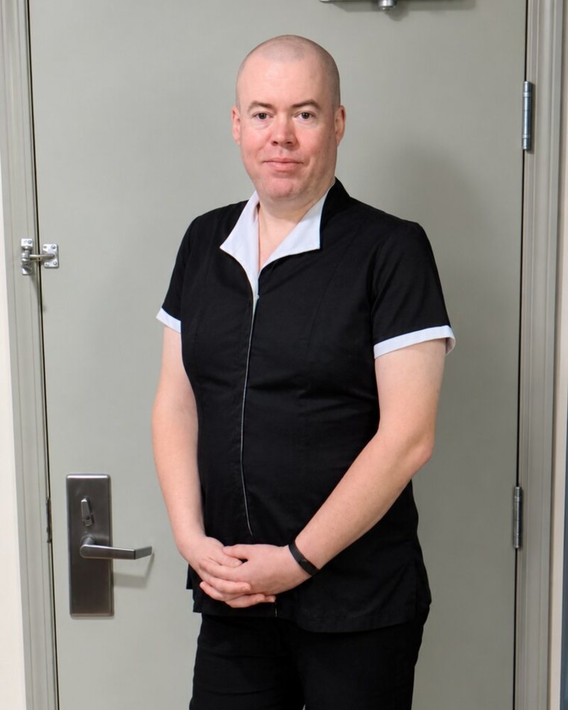 Maid Ray Berry in the black housekeeping tunic